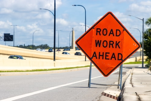Road work ahead sign representing work zone car accident lawyer concept