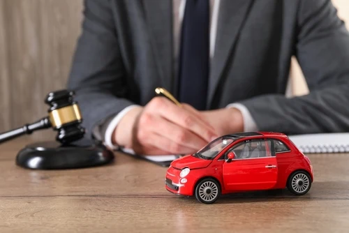 South Carolina drunk driving accident attorney at desk with toy car