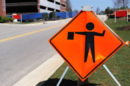 Work zone warning sign, construction zone car accident lawyer concept