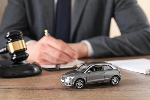 South Carolina car accident lawyer at desk with toy car and judge's gavel