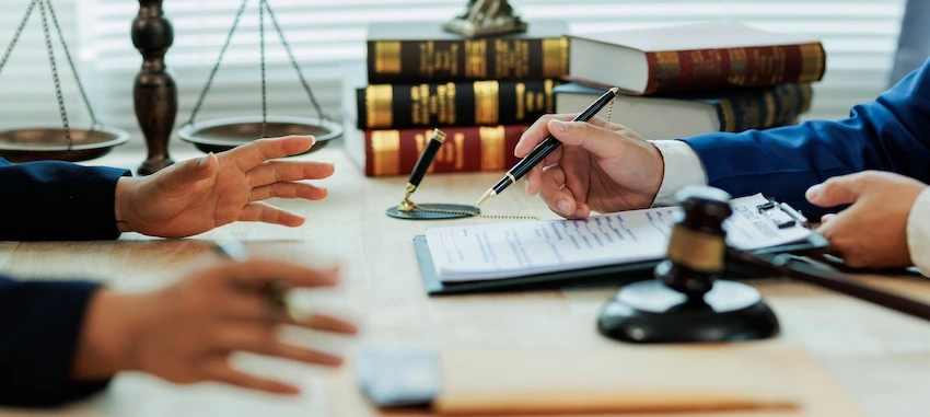 A motorcycle accident lawyer is talking with a client in South Carolina.