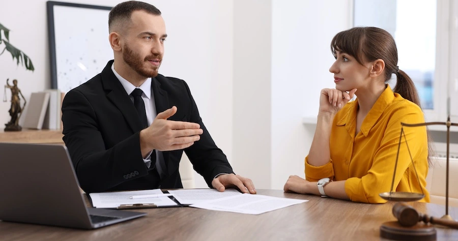 A rideshare accident lawyer is speaking with a client.