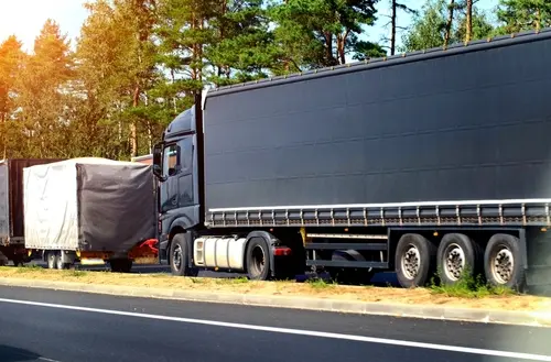 A black truck crashing into another vehicle to represent a truck accident that a truck accident lawyer will have to review.
