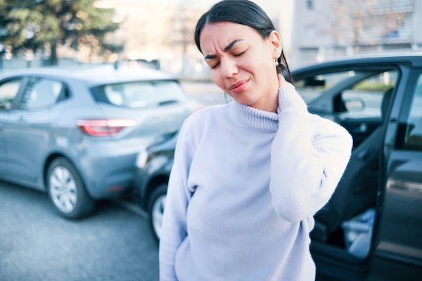 A woman suffers neck pain from a car accident injury.