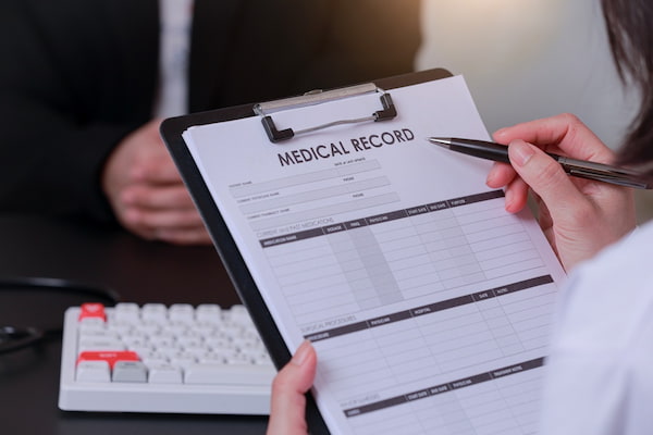 A doctor writes medical records after a car accident.