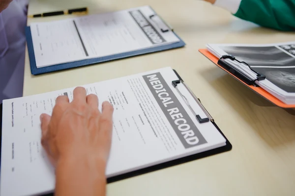 Doctors discuss medical records after a car accident.